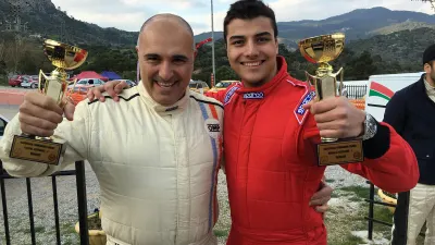 Father and Son Climb onto the Podium
