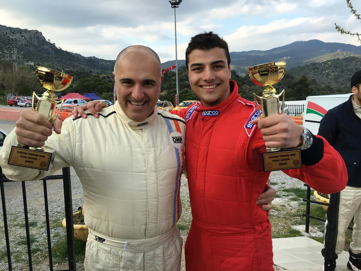 Father and Son Climb onto the Podium